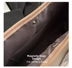 Detail of the magnetic snap closure with contrast stitching and inner fabric lining