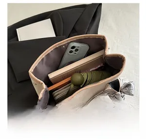 Top view of spacious interior of canvas tote bag with silk scarf decoration and daily items