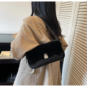 Chic black faux fur shoulder bag with silver square lock buckle shown on model