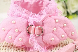 Close-up of pink lace pet harness featuring plush wings with white pearl accents