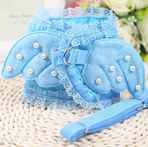 Detail of light blue denim pet harness with lace edges and 3D angel wings design