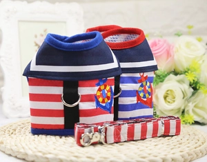 Close-up of sailor style dog harness set with anchor embroidery and striped patterns
