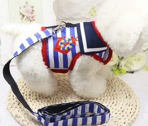 Detail of nautical dog harness set with navy stripes and anchor embroidery on a plush model