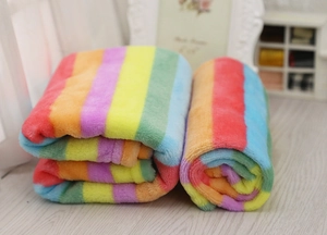 Morbida coperta in flanella a righe arcobaleno per animali su pavimento in legno
