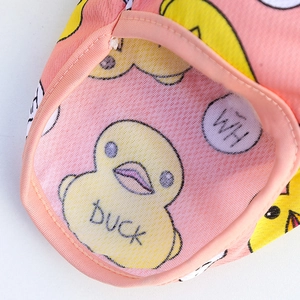Detail of pink mesh dog vest featuring breathable fabric and yellow duck patterns