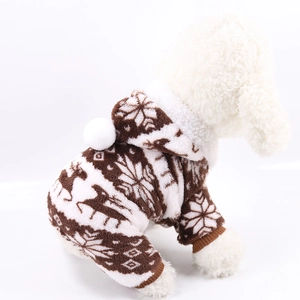 Detail of coral fleece pet pajamas featuring festive deer patterns and a white pompom ball