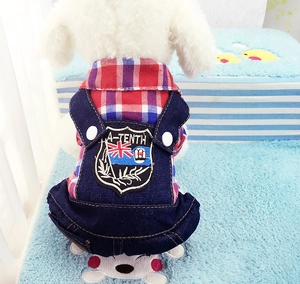 Detail of dog overall harness with red plaid shirt and denim pants with shield patch