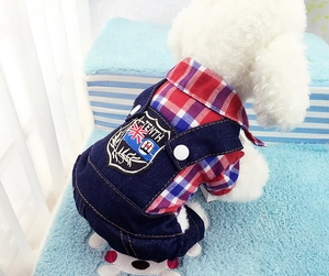 Macro shot of denim overalls for pets with red plaid shirt and branded fabric patch