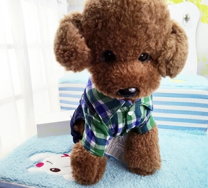 Detail view of plaid shirt and denim overalls on a small pet dog plush model