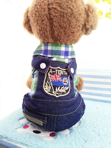 Detail of British style pet denim overalls featuring green plaid shirt and shield embroidery