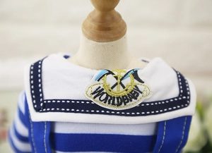 Close-up of sailor-style pet clothing with nautical anchor embroidery and stripes