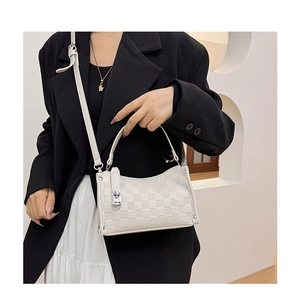 Detail of white checkered faux leather pillow bag with silver metal swivel lock buckle