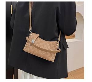 Close-up of retro plaid pattern textured crossbody bag with metal turn-lock closure