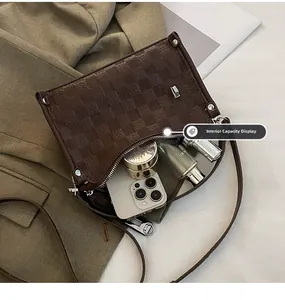 Interior view showing the large capacity of this brown checkered quilted crossbody bag