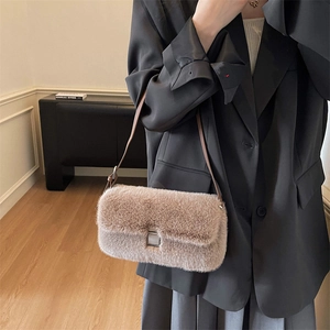 Furry brown faux fur shoulder bag with silver buckle worn with black blazer outfit