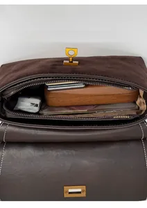 Macro interior view of brown vintage bag showing spacious compartment with zipper