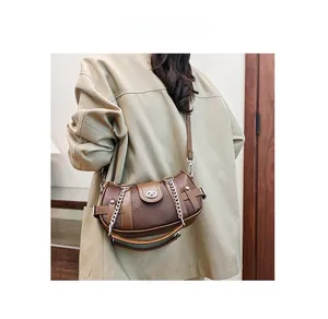 Detail of vintage brown pebble leather shoulder bag with silver chain and metal clasp