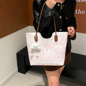 Graffiti tote bag with pink cartoon patterns, brown straps and cloud charm accessory