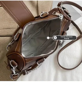 Detail of cylinder bag showing grey herringbone fabric lining and internal zipper pocket