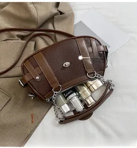 Detail view of leather shoulder bag interior showing spacious capacity for cosmetics