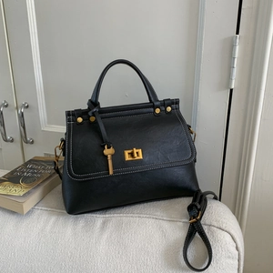 Classic black suede crossbody bag with vintage gold hardware and contrast stitching details