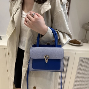 Chic blue striped patchwork leather handbag with gold U-buckle and crossbody strap