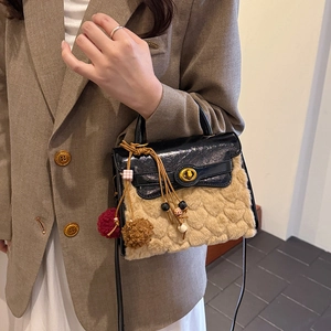 Faux fur handbag with beige wave texture and black leather flap featuring gold twist lock