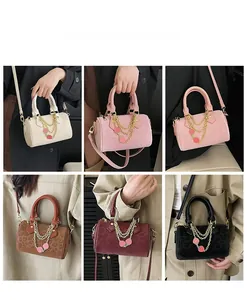 Collage of leopard print Boston bags in six colors with gold chain and strawberry charm