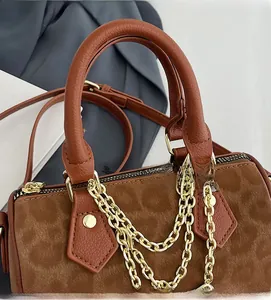 Detailed close-up of retro leopard Boston bag featuring triple gold chains and textures