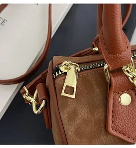 Detail of smooth gold zipper and hardware on vintage leopard print Boston bag