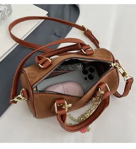 Internal view of the brown leopard Boston bag showing spacious storage for phone and lipstick
