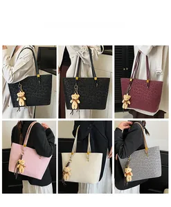Detail of leopard print tote bags in various colors with cute bear charm and shoulder straps