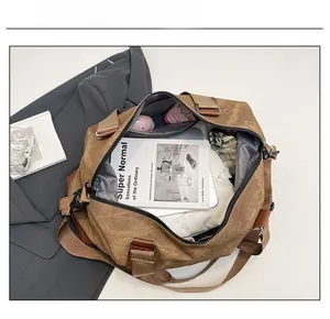 Top view showing large capacity of brown canvas travel bag with books and clothes