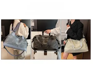 Detail of travel duffel bag showing luggage sleeve, shoulder strap, and multiple colors
