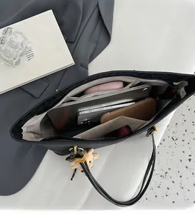 Top view of spacious interior of black leopard print tote bag with daily essentials and pockets