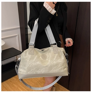 Detail of light green marble texture travel bag with dual handles and shoulder strap