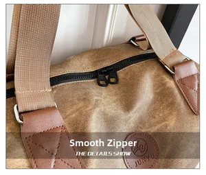 Detail of smooth double metal zippers and premium leather stitching on the canvas travel bag