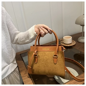 Detail of vintage brown tote bag with suede texture and Fashion & Bags embossed logo