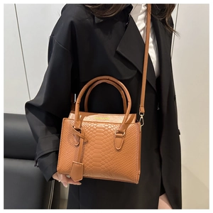 Detail of brown animal embossed texture and gold Fashion & Bags logo on stylish handbag