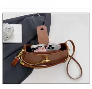 Interior view of brown matte leather bag showing capacity for phone and cards