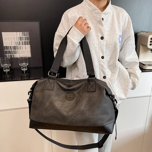 Large dark grey travel bag with retro texture and black straps for gym or business trips