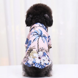 Close-up of pink Hawaiian pet shirt featuring tropical pineapple and coconut tree patterns