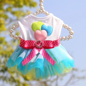 Detail of pet tutu dress with colorful heart embroidery and sparkling rhinestone bow