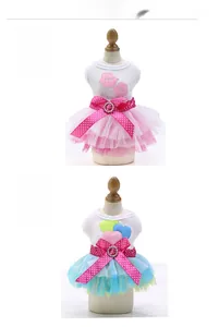 Detail of pink and blue pet tulle dresses with polka dot bows and heart embroidery