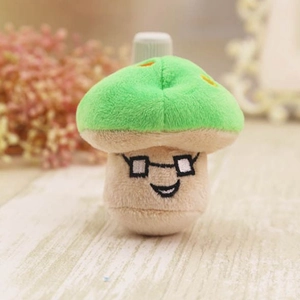 Cute green plush mushroom toy with glasses and a smiling face on a rustic wooden table