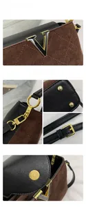 Detailed close-up of golden hardware, V-logo, and leather texture of bucket bag