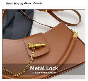 Detail of brown matte leather handbag with decorative gold metal chain and hardware clasp
