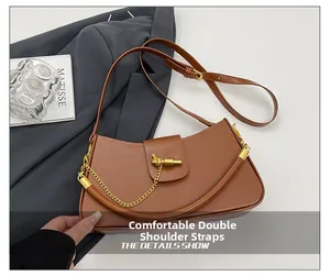 Detail of brown leather saddle bag with gold chain and comfortable dual shoulder straps