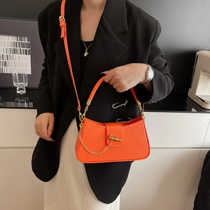Chic orange leather box handbag for women featuring a gold clasp and adjustable shoulder strap