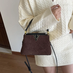 Retro brown quilted suede bucket bag with gold V logo and leather top handle